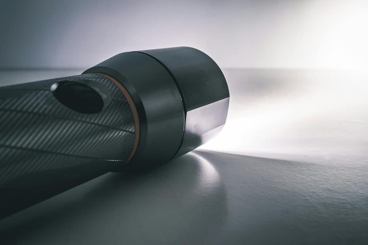 Flashlight illuminated against a dark background