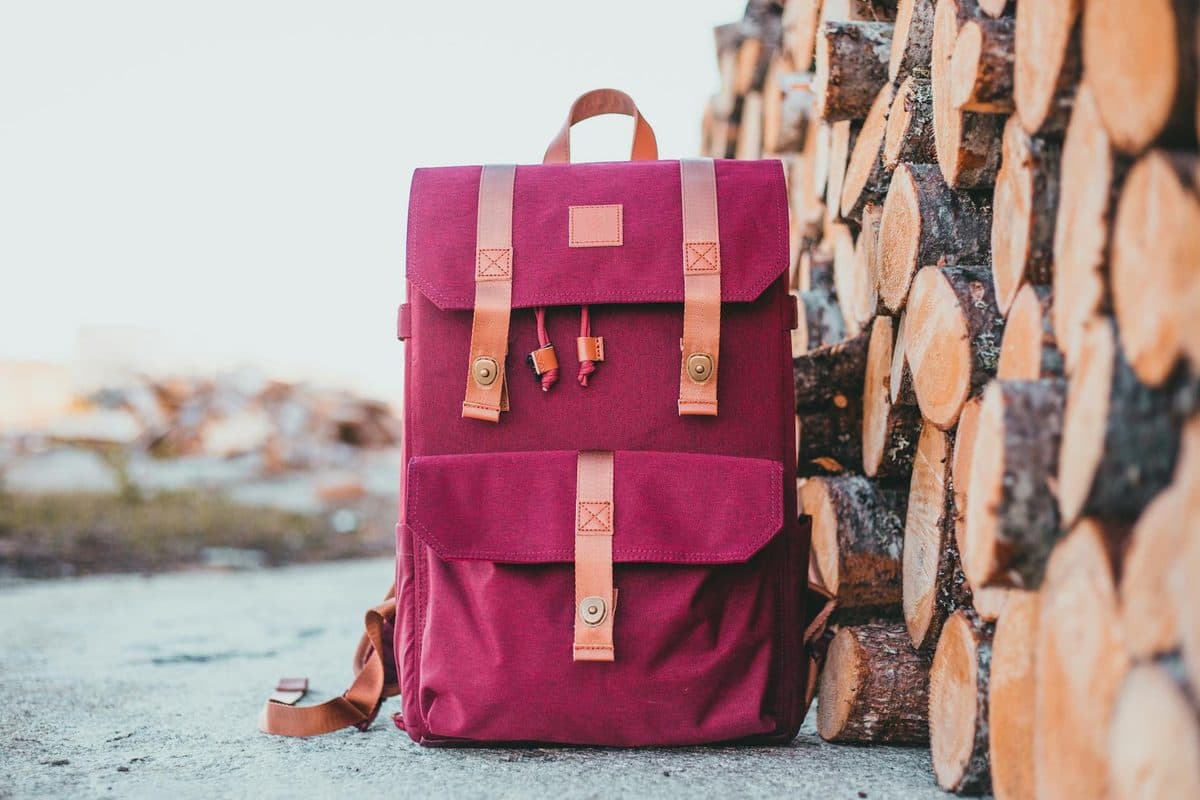 Adventure backpack with gear next to firewood